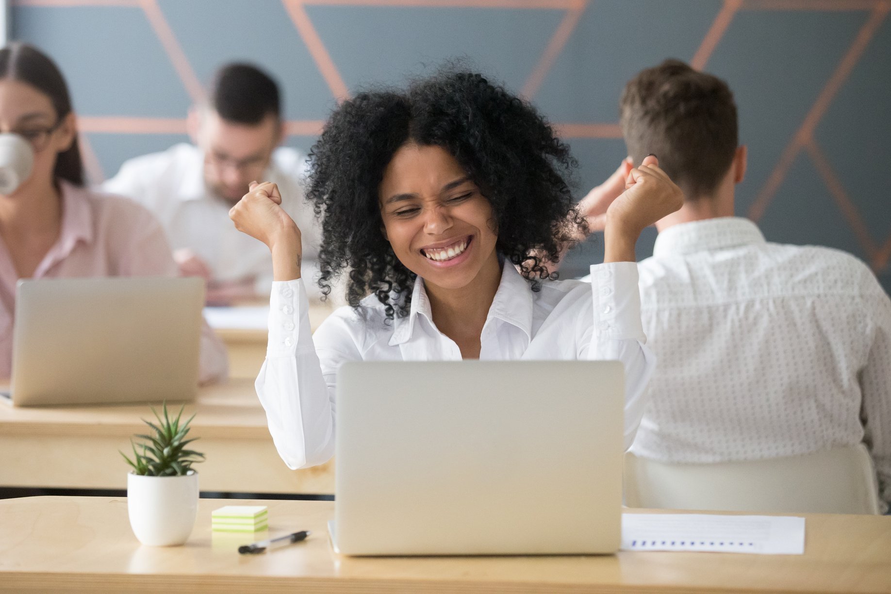 Excited black employee winning online lottery